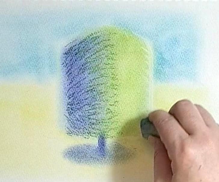四角い木に塗った色を練り消しゴムで色を抜いてハイライトを作っている様子